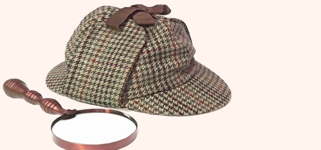 Sherlock Holmes Hat or Deerstalker Hat and Retro Magnifying Glass Isolated on White